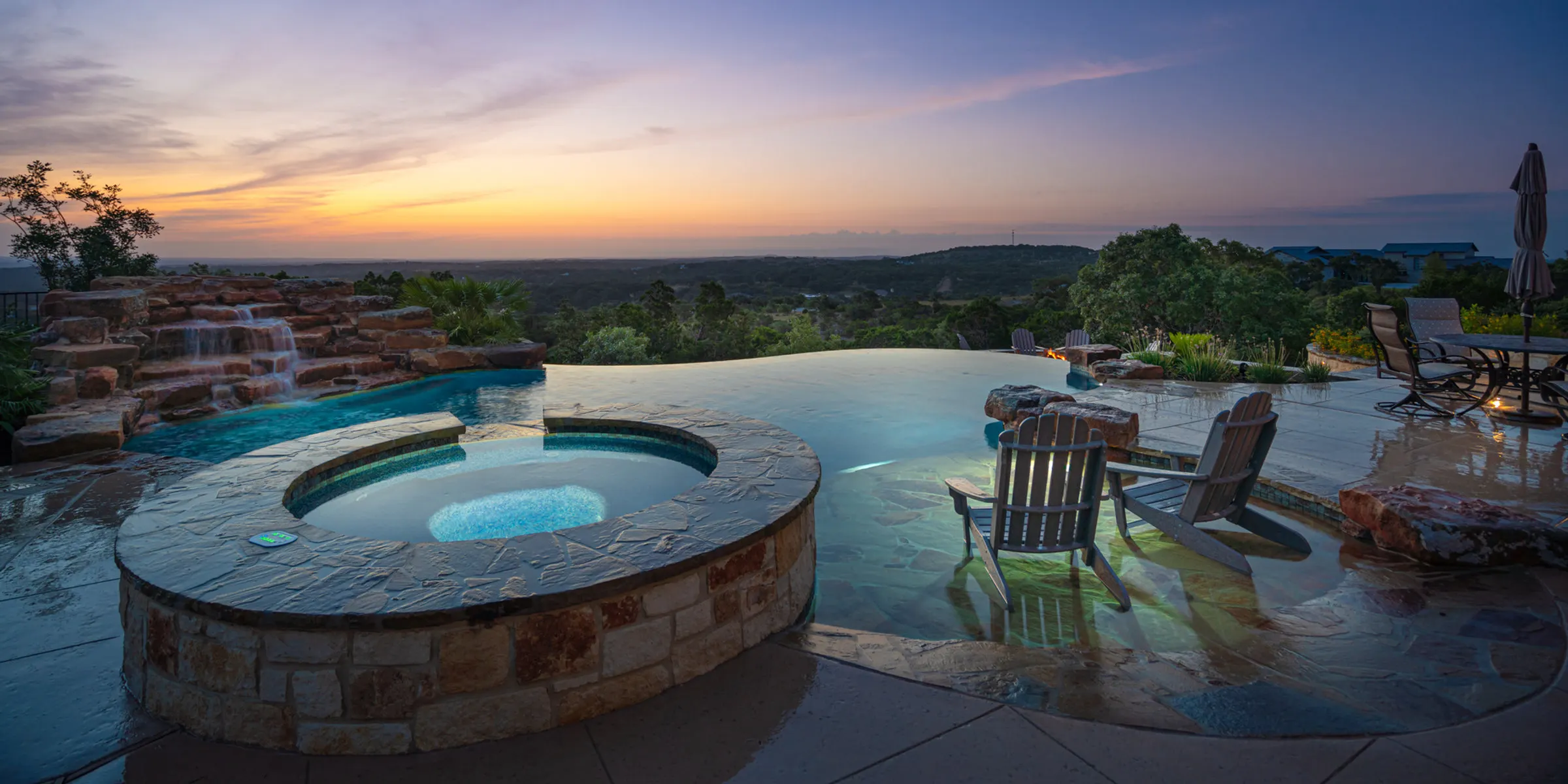 Vanishing edge pool and spa at sunset overlooking the Texas Hill Country